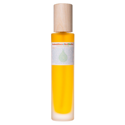 A cylindrical bottle filled with vibrant yellow liquid, which seems to be skincare oil. The bottle features a wooden cap and a label with text wrapped around its upper portion. The product name "Best Skin Ever Cleanser - Seabuckthorn" from Living Libations is clearly visible on the label, emphasizing its infusion of botanical compounds and organic oils.