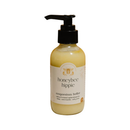 A Honeybee Hippie magnesium butter bottle, featuring a pump dispenser and set against a plain black background, boasts a label promising enhanced relaxation, restful sleep, and relief for sore muscles and achy joints.