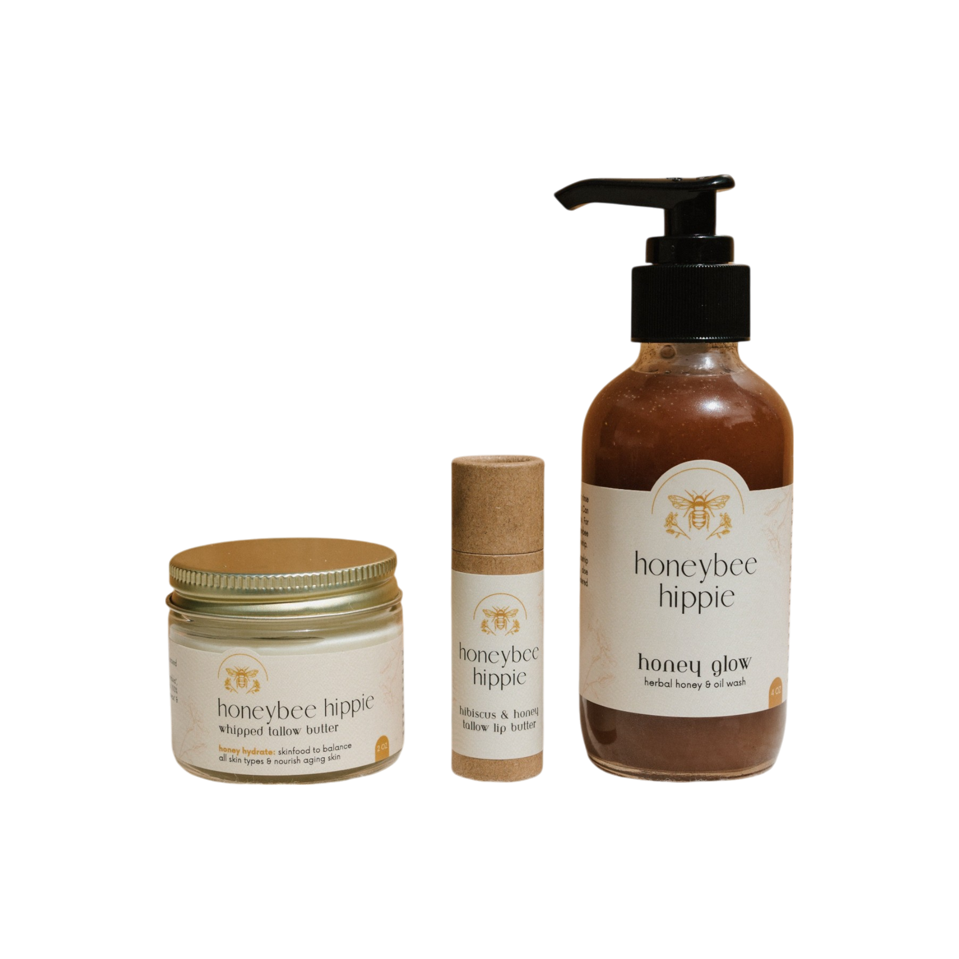 The Honeybee Hippie's "The Honey Bundle" includes a whipped kokum butter jar, kokum and honey balm stick, and herbal honey shower gel pump—all with natural ingredients for skin health, featuring cream-colored labels with minimalist design on a black background.