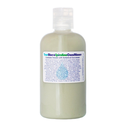 A white bottle of Living Libations True Blue Spirulina Conditioner with a white flip-top cap. The label, adorned with blue and green text, details the product's features and ingredients, including azulene essential oils. Perfect for dry hair, the conditioner boasts a creamy light green color.