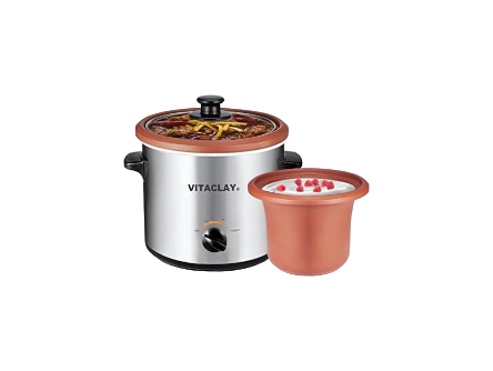 A VitaClay® Chef VITACLAY 3-IN-1 Clay Slow Cooker, Yogurt Maker, Baby Food Maker (VS7600-2C / 2 QUART) in silver with a black knob and handles is shown cooking food, with visible vegetables under the glass lid. Next to it is a smaller clay pot from the same product line filled with probiotic-rich yogurt topped with red pomegranate seeds. Both items are set against a white background.