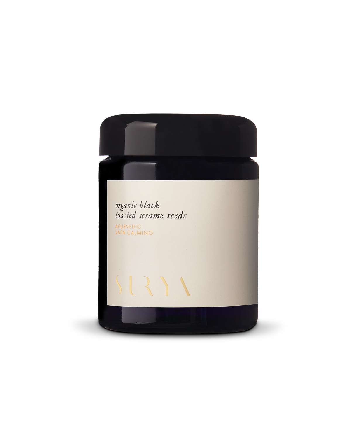 A black jar with a cream-colored label displays the text "Organic Black Sesame Seeds" and "VATA CALMING, AYURVEDIC, SURYA." Packed with antioxidants and protein, the round jar features a sleek black lid.