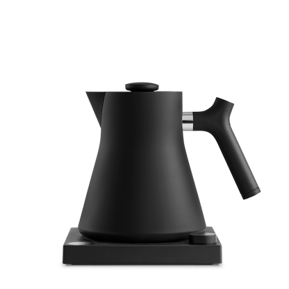 The Corvo EKG Electric Kettle by Fellow Wholesale is a precision-engineered, matte black appliance with a modern design. It boasts a curved spout and handle, set on a matching black base. The simple and minimalist style underscores both functionality and elegance, while the variable temperature control guarantees perfect brewing every time.