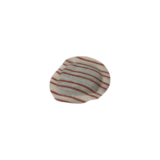 The "LAVENDER DISK linen" by cabane childrenswear is a round, flat object with red and white stripes. Made from lightweight organic linen, it features a slightly wrinkled texture and is displayed on a plain black background.