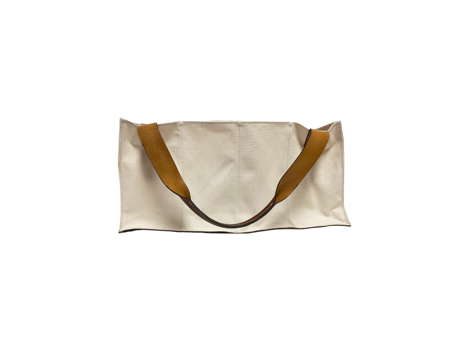 An Agnes Baddoo Market Sac with beige canvas and brown leather handles is pictured against a white background. The bag's simple, unadorned aesthetic highlights its minimalist design.