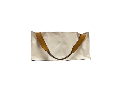 An Agnes Baddoo Market Sac with beige canvas and brown leather handles is pictured against a white background. The bag's simple, unadorned aesthetic highlights its minimalist design.