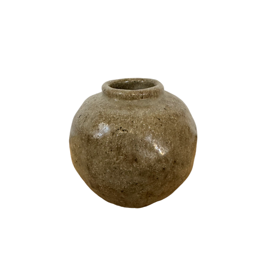 A round, handcrafted stoneware vase from Shoppe Maison features a weathered surface and a narrow opening at the top. Named the Vintage Small Stoneware Vase, it boasts a rustic, natural appearance with various shades of brown and a slightly textured, speckled finish. It is elegantly displayed against a black background.