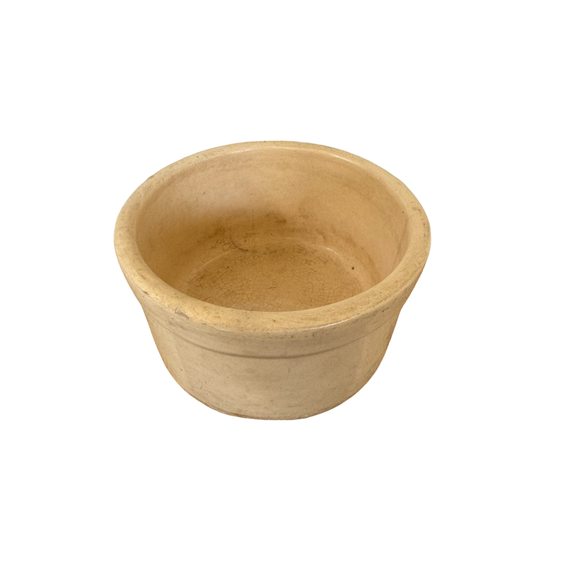 A round, beige ceramic bowl with a slightly textured surface and a smooth rim, reminiscent of vintage stoneware crock pieces. The Vintage Small Stoneware Crock by Shoppe Maison is empty and placed against a plain, black background, perfect for showcasing their curated collection of vintage goods.