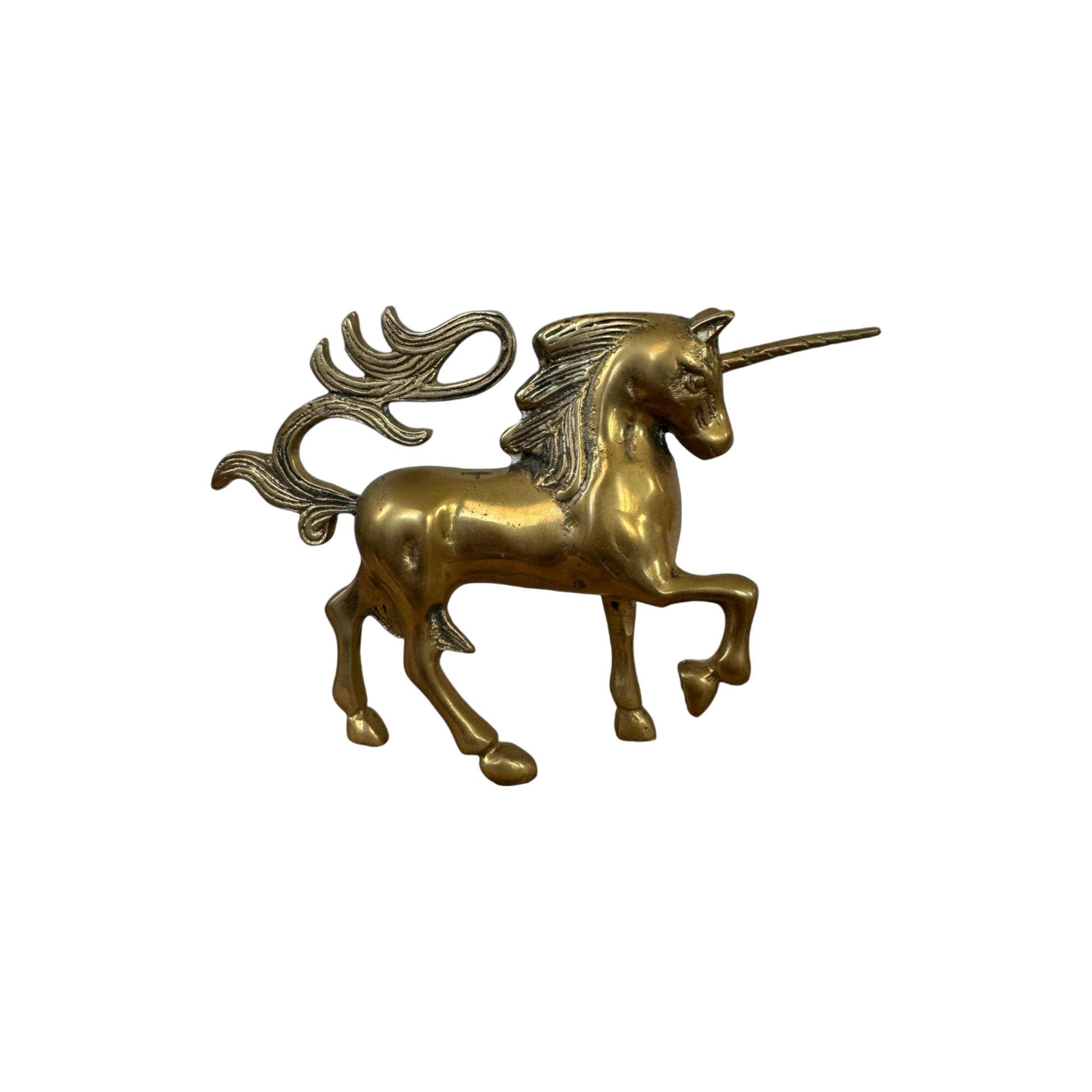 The Mini Brass Unicorn from Shoppe Maison is a gold-toned figurine, featuring a flowing mane and tail, standing on three legs with one front leg raised. Intricately detailed to emphasize its mythical nature, it is perfect for collectors of vintage goods and contrasts beautifully against a solid black background.