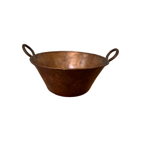 A Large Vintage Copper Pot by Shoppe Maison features a wide opening and two rounded handles on either side, set against a plain black background. Its slightly tarnished, weathered appearance indicative of age and use makes it perfect for kitchen decor or even repurposing as an elegant ice bucket.