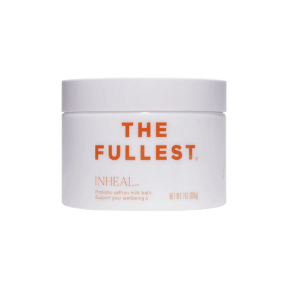 A white jar of THE FULLEST Inheal® Probiotic Saffron Milk Bath with organic goat milk powder. The label, in orange text, highlights its benefits for wellbeing and skin hydration and states the net weight as 7 oz (200g).