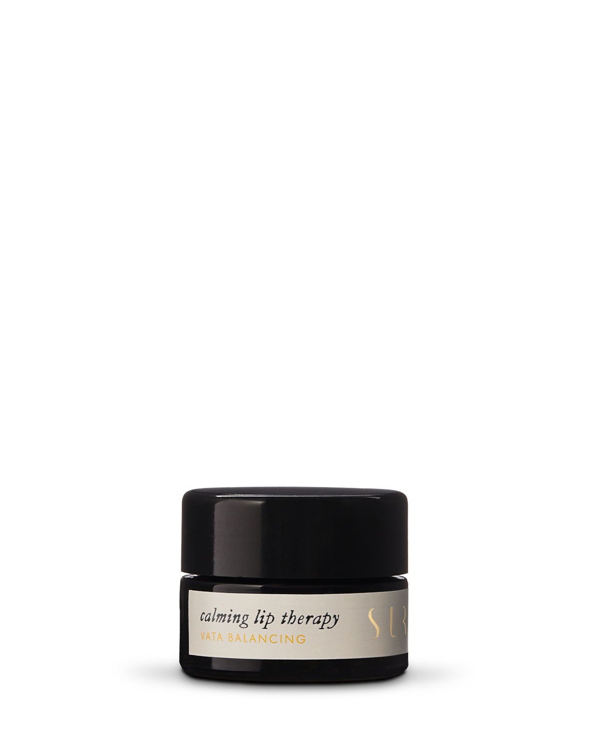 A small, black cylindrical jar labeled "Calming Lip Therapy - Vata Balancing" from the brand Surya. The jar features a black lid and an off-white label with subtle text. The product, with a creamy formula and organic ingredients, is designed for moisturizing lip care.