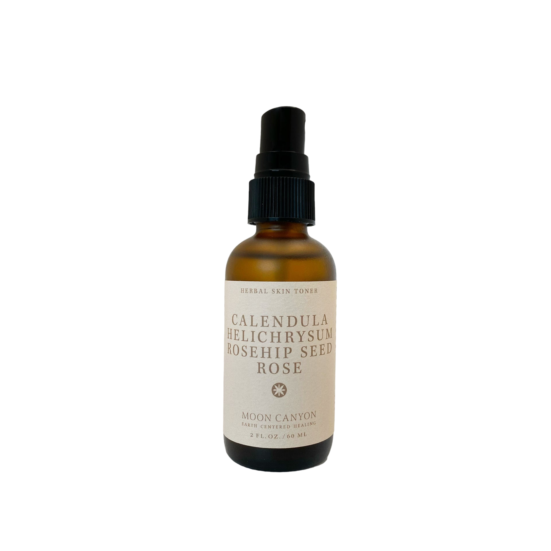 A brown glass bottle with a black pump dispenser labeled "Herbal Skin Toner" from Moon Canyon Healing features anti-inflammatory herbs such as Calendula, Helichrysum, and Rosehip Seed Rose. The 2 FL. OZ. / 60 ML bottle contains organic ingredients.