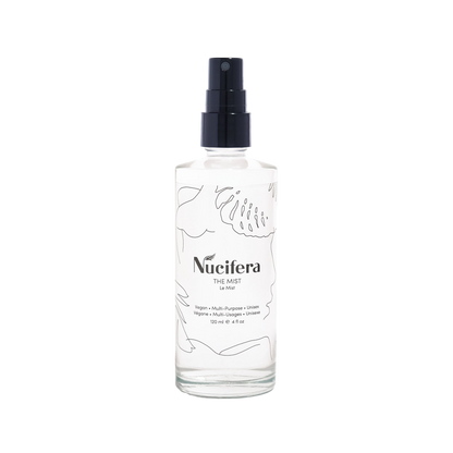 A bottle of Nucifera Body Store's The Mist. The clear bottle with a black spray nozzle is adorned with minimalist line illustrations of plants. The label highlights that it is a vegan, multi-purpose balm presented in a fine mist spray form, suitable for all genders, and contains 120 ml (4 oz).