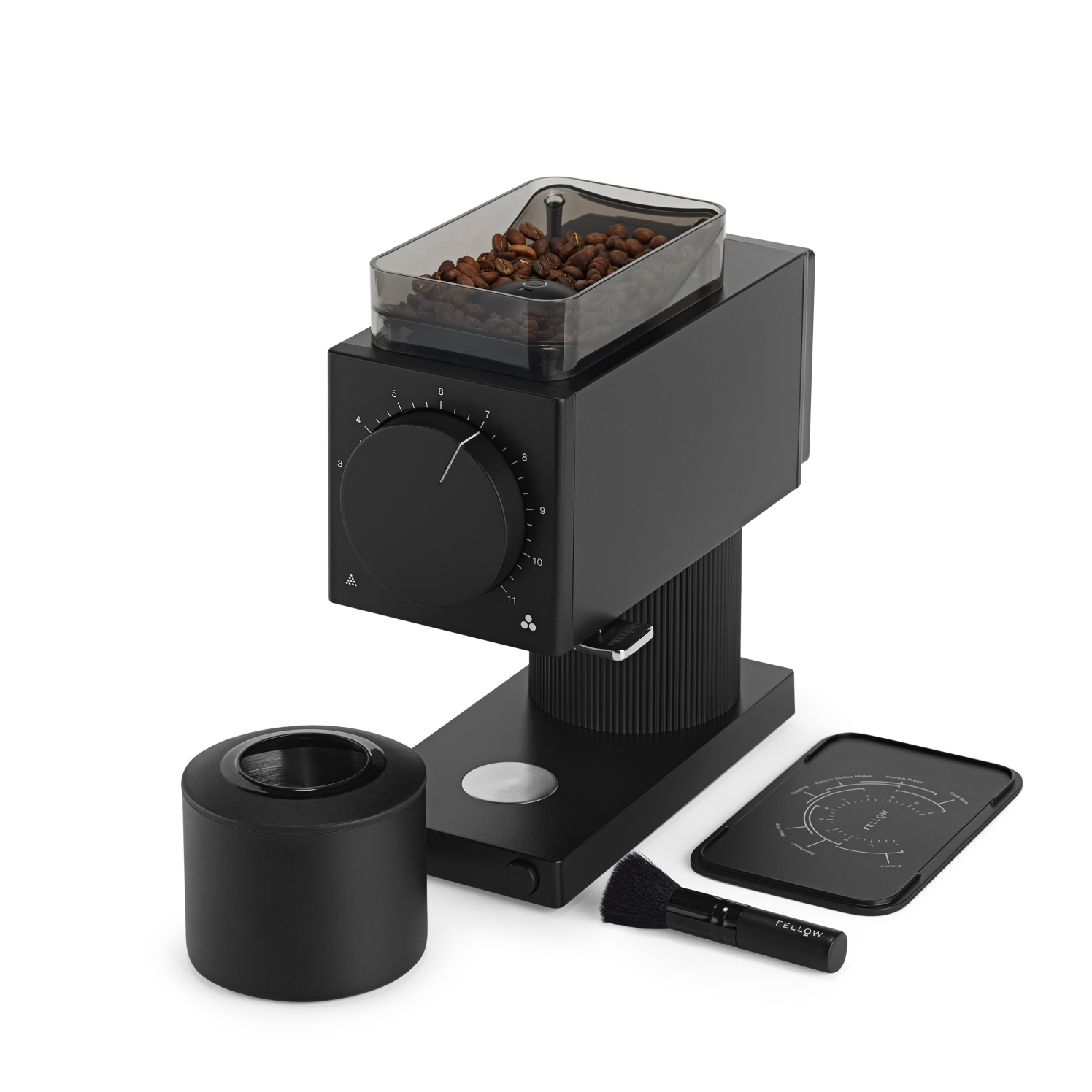 The Fellow Wholesale Ode Brew Grinder is a sleek black coffee grinder with a transparent container for holding coffee beans on top. It features Gen 2 Brew Burrs and offers 31 grind settings, complemented by a large dial on the front. The setup includes a brush, a cylindrical container for grounds, anti-static technology, and a digital scale with minimalist design accents.