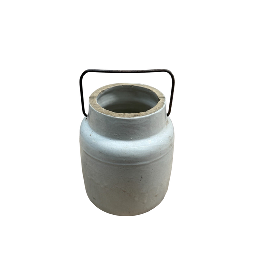 A grey, cylindrical ceramic jug with an open top and a bail wire handle is centered on a plain black background. Resembling a vintage stoneware milking crock, the Vintage Stoneware Milking Jug from Shoppe Maison has a slightly tapered shape with a wide mouth, showcasing its rustic and minimalistic design.