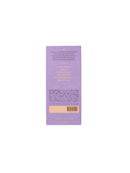 An image of the back of a purple chocolate bar packaging showcases "Spring & Mulberry" branding. The text highlights ingredients like cacao beans, raw honey, and organic elements such as various berries. It's the Mixed Berry Date-Sweetened Chocolate with detailed nutritional information and serving size.