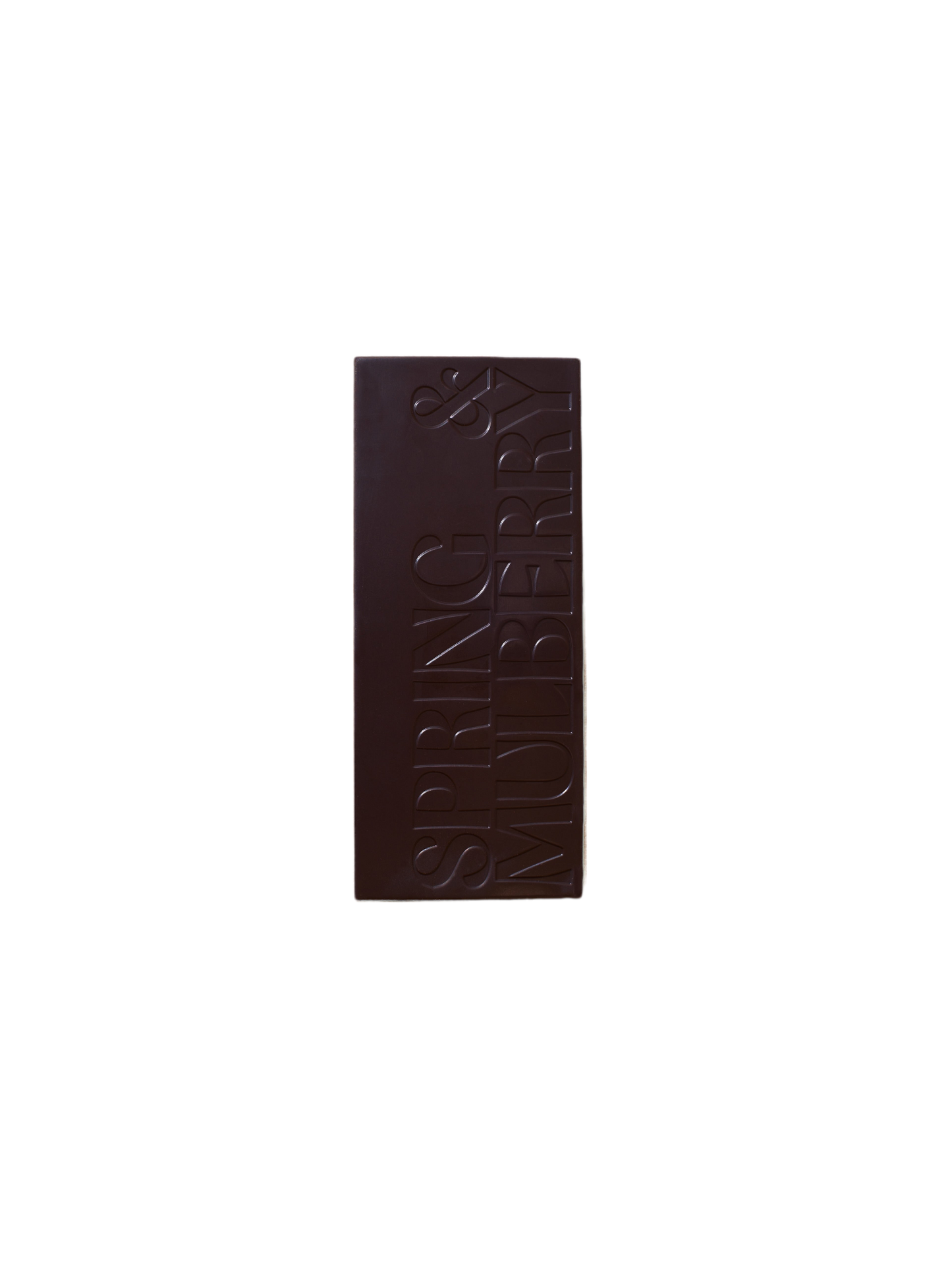 A Pure Dark Date-Sweetened Chocolate bar from Spring & Mulberry, with "SPRING & MULBERRY" engraved in large, bold letters vertically aligned on its surface against a plain black background.