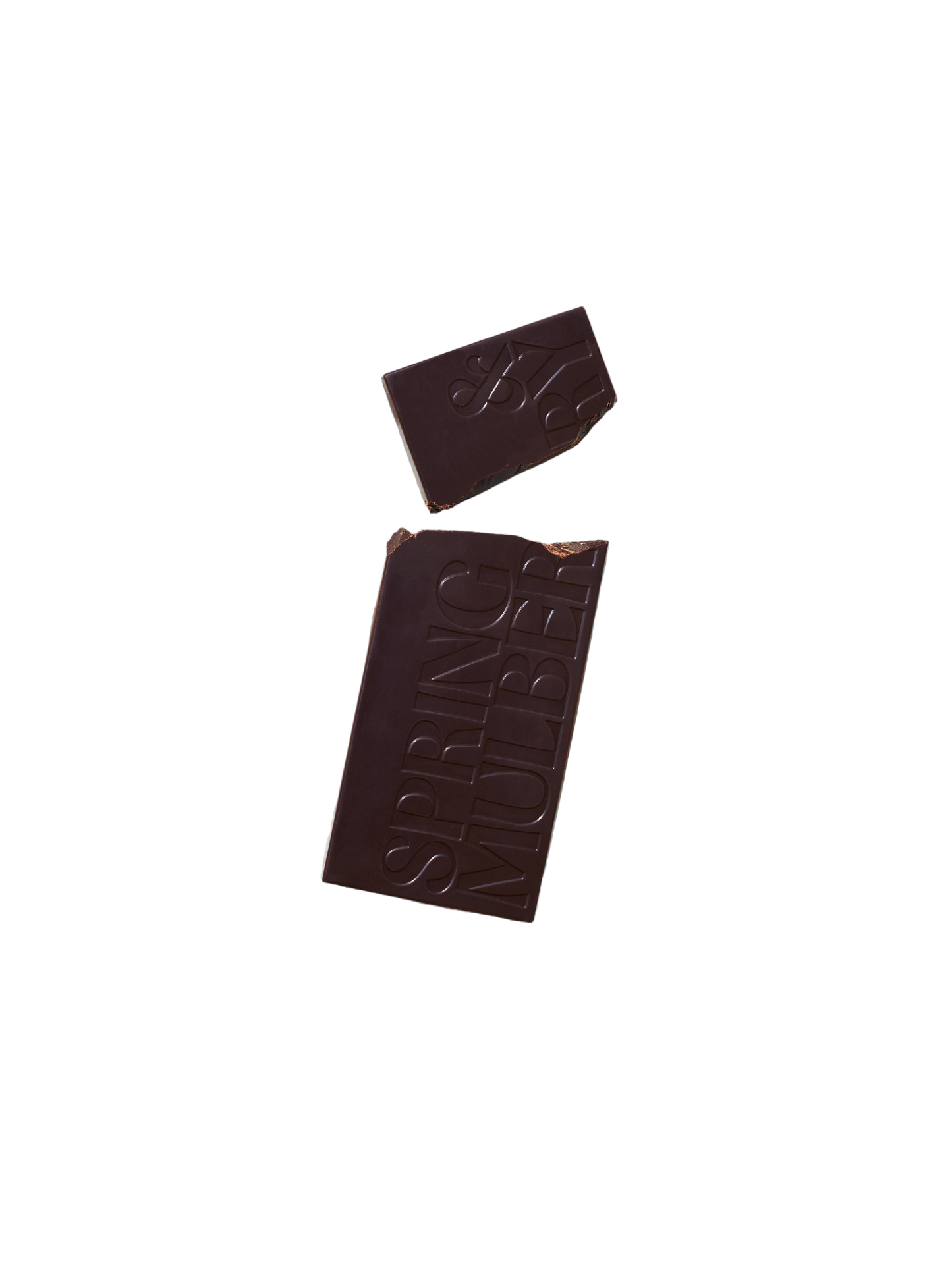 A bar of Pure Dark Date-Sweetened Chocolate with a small broken-off piece on a black background. The larger section of the chocolate bar has the words "Spring & Mulberry" embossed on it, showcasing its rich, date-sweetened chocolate origin.