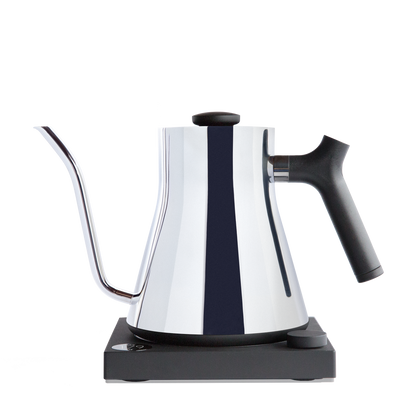 The Stagg EKG Electric Kettle by Fellow Wholesale boasts a sleek, modern design with a polished stainless steel body and a long, precise gooseneck spout. It sits elegantly on its black base and features a black, ergonomic handle along with a well-designed knob on the lid for precise pouring.