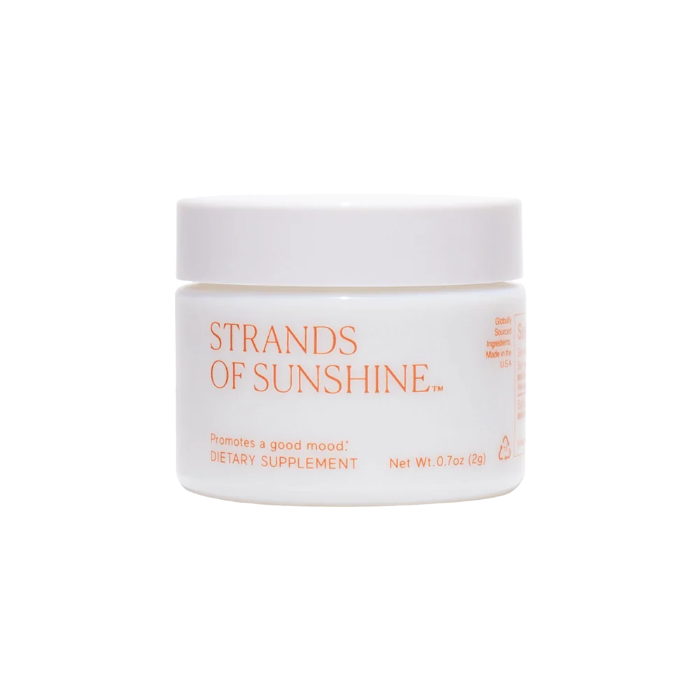 A white, round container with an orange lid, labeled "Strands of Sunshine" by THE FULLEST. Described as a dietary supplement containing medicinal saffron, the front text indicates it promotes a good mood and provides anxiety support. The net weight is 0.7 oz (20g).