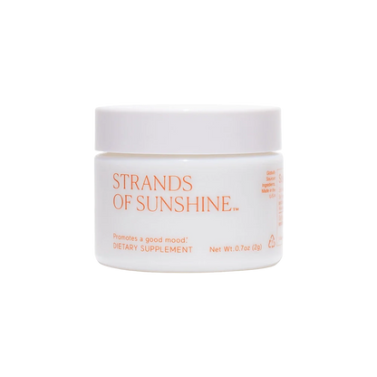 A white, round container with an orange lid, labeled "Strands of Sunshine" by THE FULLEST. Described as a dietary supplement containing medicinal saffron, the front text indicates it promotes a good mood and provides anxiety support. The net weight is 0.7 oz (20g).