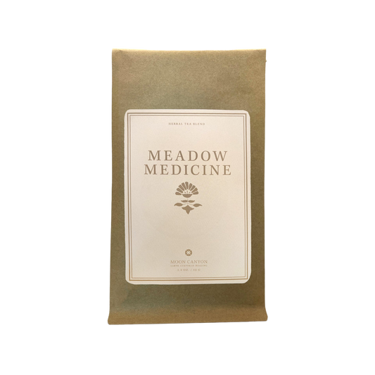 A brown paper pouch labeled "MEADOW MEDICINE TEA BLEND" in capital letters is pictured. The label features an illustration of a plant and the text "HERBAL TEA BLEND" above and "MOON CANYON HEALING" 