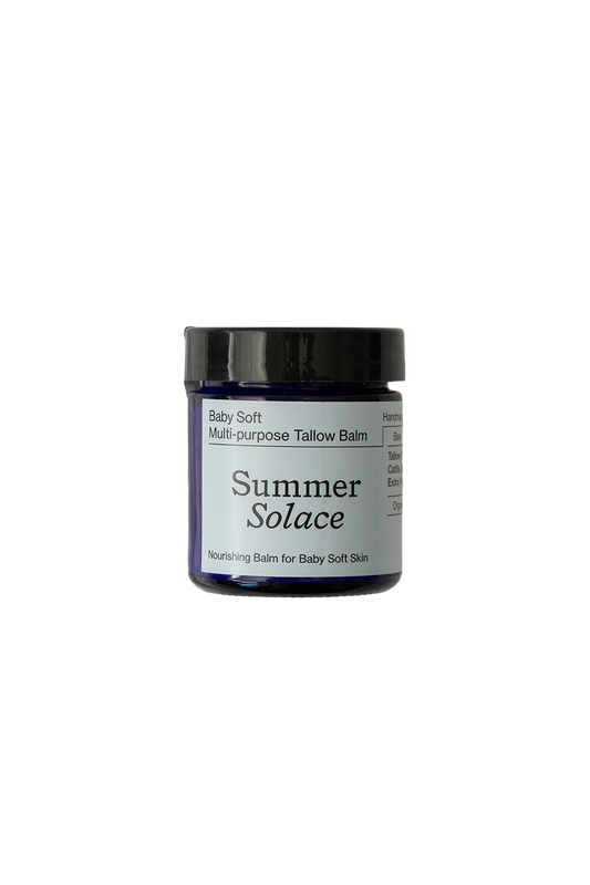 A jar of Summer Solace Tallow Baby Soft Family Balm - Regenerative Tallow™ + Pastured Leaf Lard with a black lid. The light blue label reads "Nourishing Balm for Baby Soft Skin." Ideal as a baby moisturizer, it's perfect for sensitive skin. The jar sits against a plain black background.