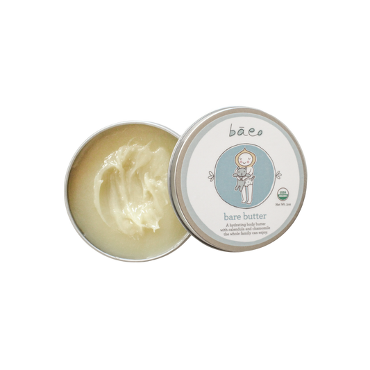 An open tin of bāeo bare butter body butter, showcasing a creamy, white product inside. The lid, placed to the side, displays the brand name "bāeo" along with an illustration of a child cradling a bear. This 3 oz tin provides hydrating benefits from natural ingredients and is suitable for the entire family.