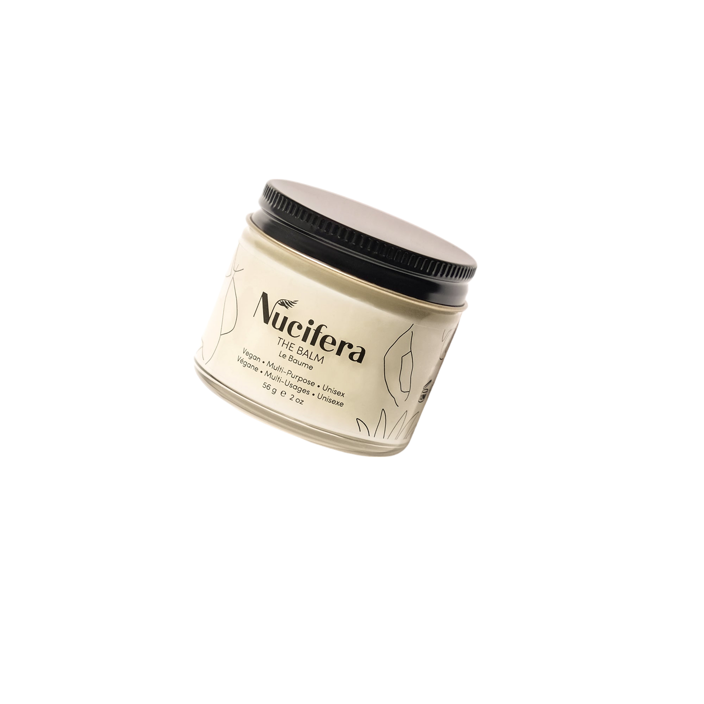 A beige jar of "The Balm" from Nucifera Body Store's The Essentials Kit, complete with a black lid, set against a black background. The label showcases the brand name and product details, enhanced by minimalist leaf illustrations. The jar is tilted, highlighting the versatile skincare packaging design.