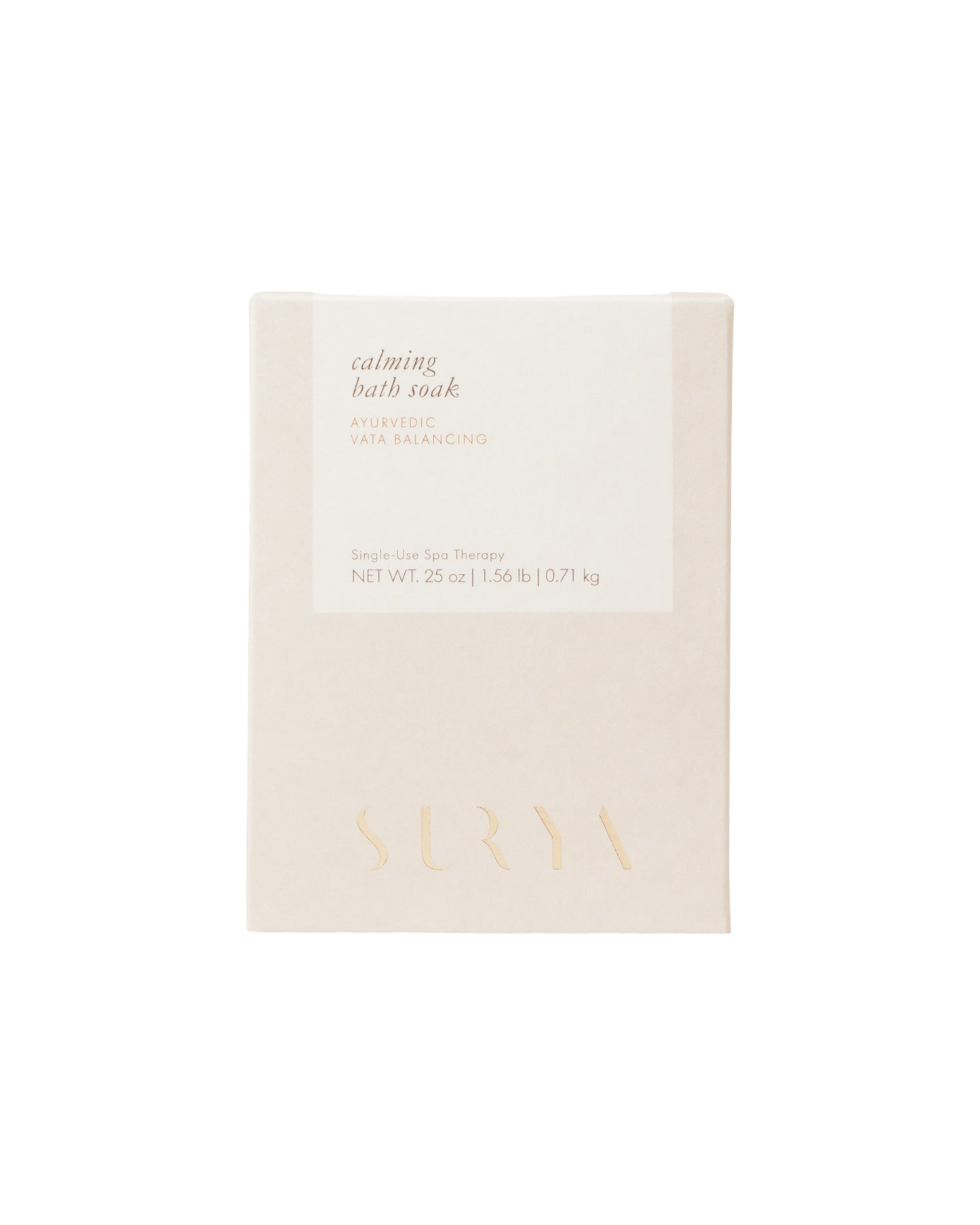 A beige package of Surya's Calming Bath Soak, with details in soft light brown and gold text. Enriched with Ashwagandha and natural salts, this Ayurvedic Vata Balancing bath soak weighs 0.25 oz (7 g). The minimalist design emphasizes relaxation and therapeutic benefits.
