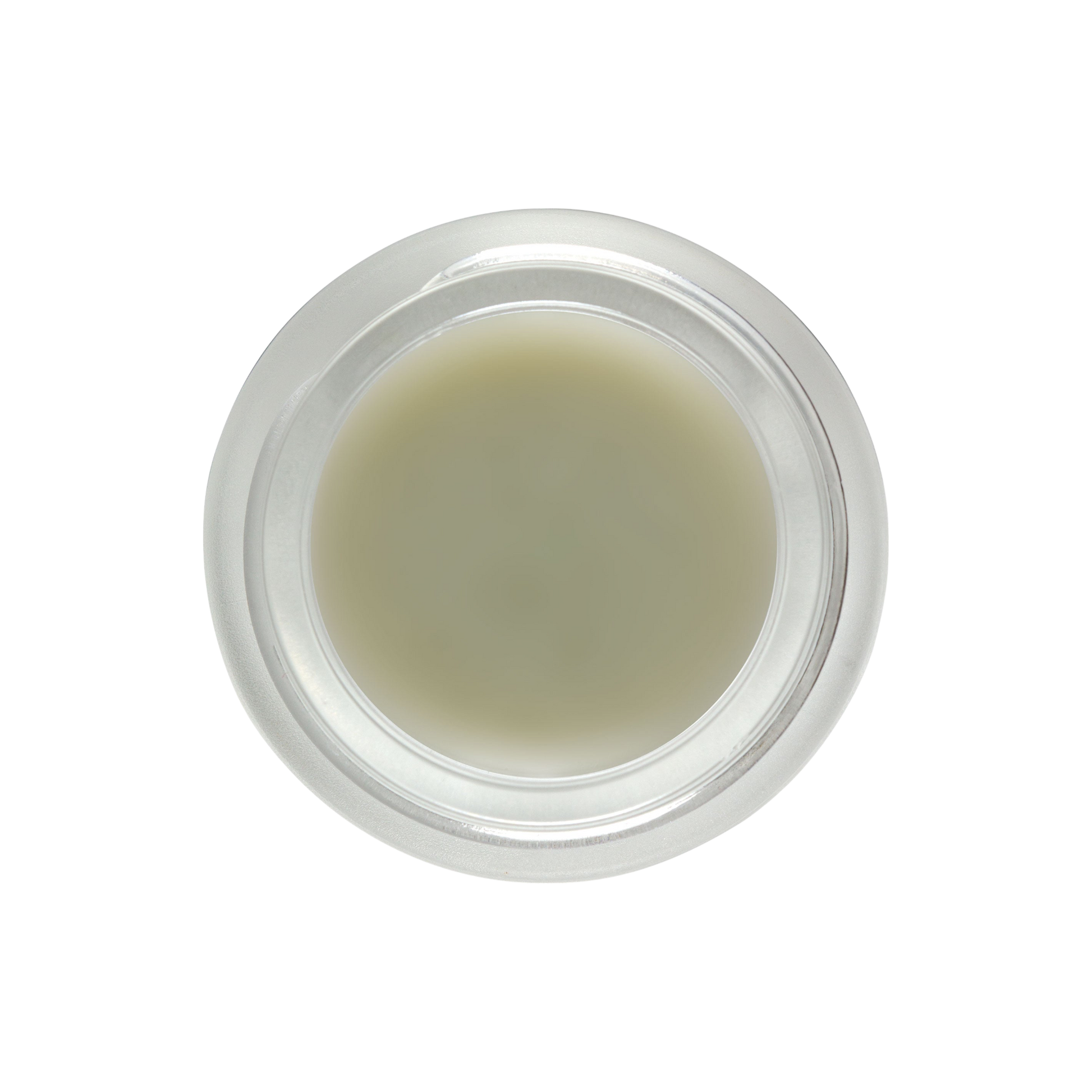 A top-down view of a clear, round container filled with Living Libations' DewDab - Ozonated Beauty Balm in a light beige hue. The container features a smooth, transparent lid. Set against an entirely black background, the container and its pure plant intelligence contents become the focal point of the image.