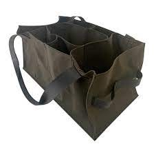 A dark brown Agnes Baddoo Market Sac with four compartments and two sets of handles, one long for carrying over the shoulder and one short for hand carrying. The Market Sac is empty and stands upright on a flat surface.