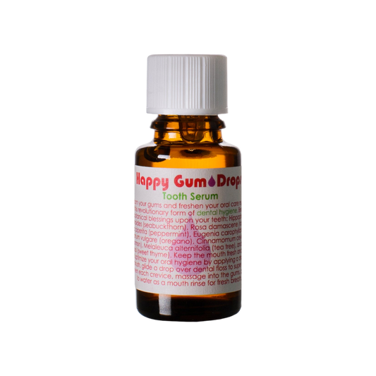 A small amber bottle with a white cap, labeled "Happy Gum Drops" by Living Libations. The label showcases vibrant text, highlighting natural ingredients and providing detailed usage instructions for dental hygiene. The bottle is striking against a black background.