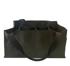 A large Market Sac by Agnes Baddoo, crafted from black leather and canvas, is shown. Featuring multiple compartments and a wide shoulder strap, the bag appears spacious with several exterior pockets for additional storage.
