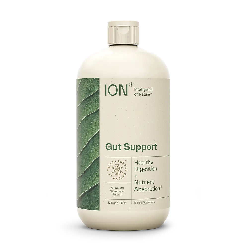 A white bottle labeled "ION* Gut Support" with a leaf design on the left side. The label states "Healthy Digestion + Nutrient Absorption" and highlights "All Natural Microbiome Support." This daily wellness supplement by ION* contains 32 fl oz (946 ml) of mineral support for optimal gut health.