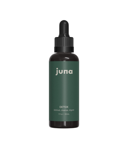 Product Description: A small dark glass bottle with a dropper cap featuring a green label. The label reads "Juna" at the top, followed by "Chlorophyll Detox Drops," with the description "debloat, cleanse, liver detoxification, healthy digestion" beneath. The bottle is 1 fl oz / 30 ml. The background is black.