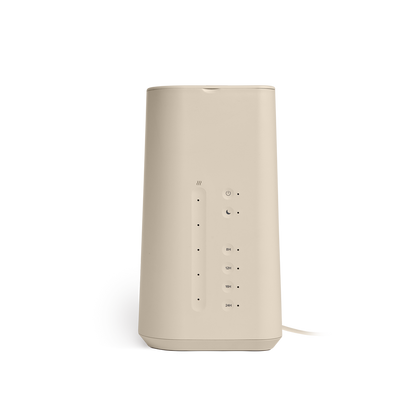 The Cloud Humidifier by Vitruvi is a beige, cylindrical electronic device featuring multiple small indicator lights in a vertical line, buttons for adjustable mist levels, and ports on its front. Utilizing ultrasonic technology, the Cloud Humidifier showcases a flat top and bottom with a smooth, minimalist design.