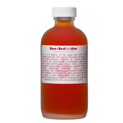 A brown glass bottle with a white cap contains "Best Skin Ever Cleanser- Rose" by Living Libations. The label highlights skin-benefiting ingredients such as rose otto, jojoba oil, coconut oil, lavender, and vetiver. Instructions detail its use as a face and body moisturizer for enhancing your skin's radiance.