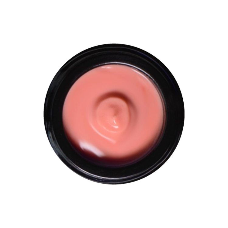 A top-down view of an open jar reveals a smooth, pink-colored Rose Glow Crème. The jar has a black rim, and the cream appears freshly used with a small dip in the center. This luxurious botanical moisturizer by Living Libations promises nourishment, infused with rose hydrosol for added benefits. The background is transparent.
