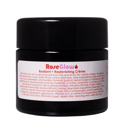 A black cylindrical container with a white label displays the product name "Rose Glow Crème" by Living Libations. This botanical moisturizer features rose hydrosol, and the label lists ingredients and usage instructions in small text.