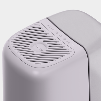 Close-up of a modern light purple Bedside Humidifier 2.0 with a vented top and control symbols. The smooth surface displays the Canopy brand name on the vent, provided by Canopy for your air humidification needs.