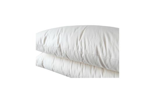 The Ashland Organic Wool Pillows from Shepherd's Dream are stacked on top of each other against a transparent background. These natural sleep pillows, with their fluffy white appearance, look soft and inviting while featuring neatly aligned seams and a smooth texture.