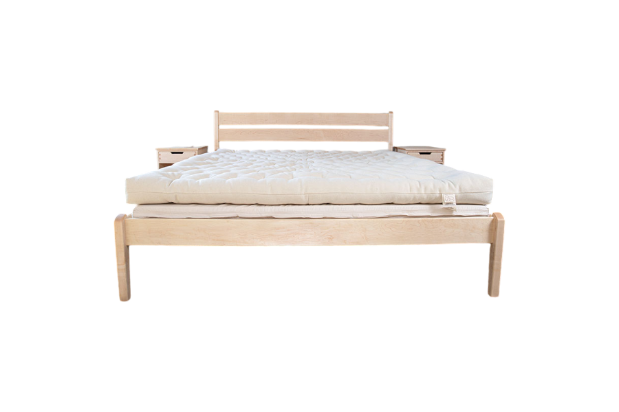 Introducing the minimalist wooden bed featuring the All Wool Mattress by Shepherd's Dream. This bed includes a simple headboard and two small attached side tables, seamlessly blending modern design with understated style and comfort. The product is beautifully showcased against a plain white background.