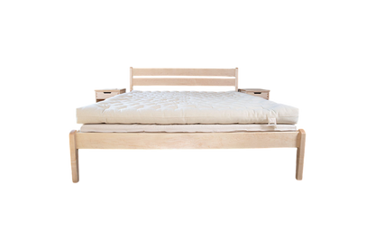 Introducing the minimalist wooden bed featuring the All Wool Mattress by Shepherd's Dream. This bed includes a simple headboard and two small attached side tables, seamlessly blending modern design with understated style and comfort. The product is beautifully showcased against a plain white background.