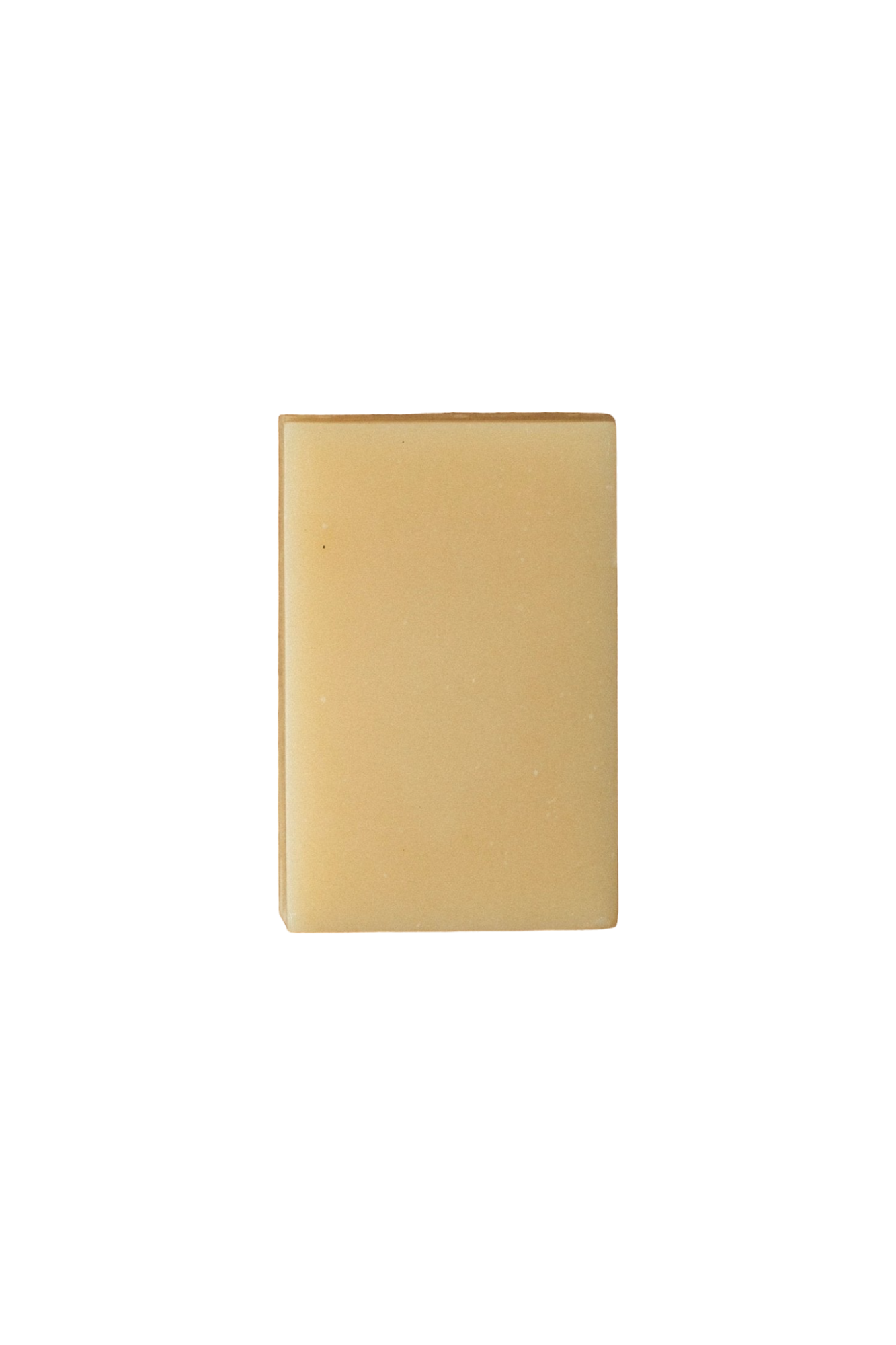 A plain, square-shaped, tan soap bar with smooth edges and minimal texture, set against a solid black background. Infused with Lemon Basil essential oil, the simple design and neutral color give the Violet and Lemon Basil A2/A2 Milk Soap - Regenerative Tallow® by Summer Solace Tallow a clean and minimalist appearance.